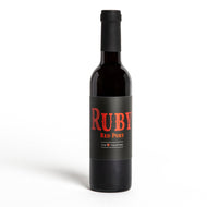 A bottle of ruby wine with red font and the number seven. The words listed are ruby red port gem collection.