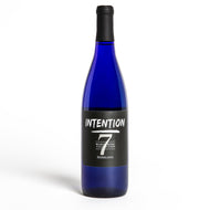 A bottle of intention wine with white font and the number seven. The words listed are intention, Word Wine Collection, and riesling.