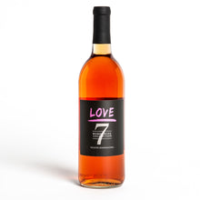 Load image into Gallery viewer, A bottle of love wine with pink font and the number seven. The words listed are love, Word Wine Collection, and white zinfandel.